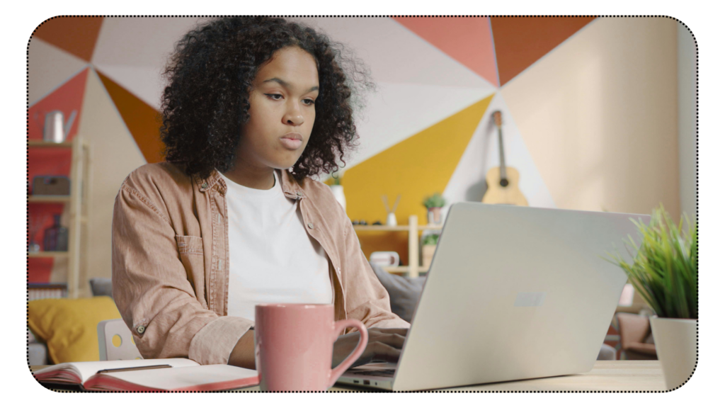 Woman working at her computer, studying intensely.