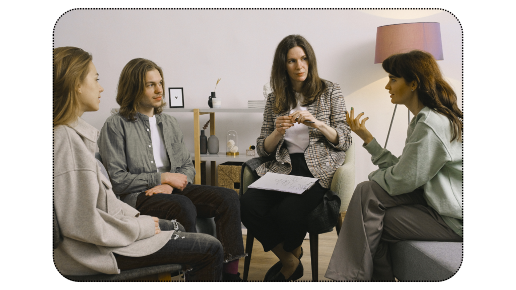 Group of four, discussing a clinical care, looking curious. 