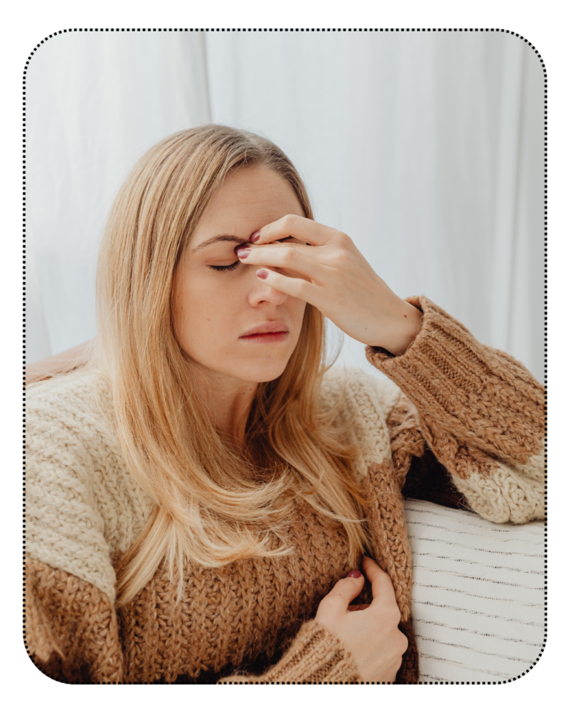 Woman looking sad and frustrated, she sits holding her face like she is deep in thought and consideration